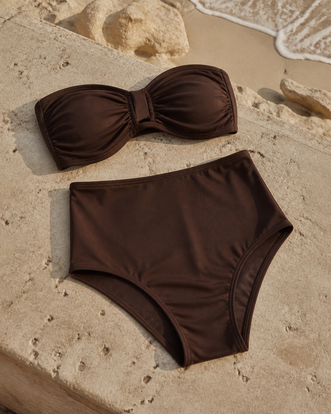 Brown bandeau bikini with a high-waisted bottom beside the beach